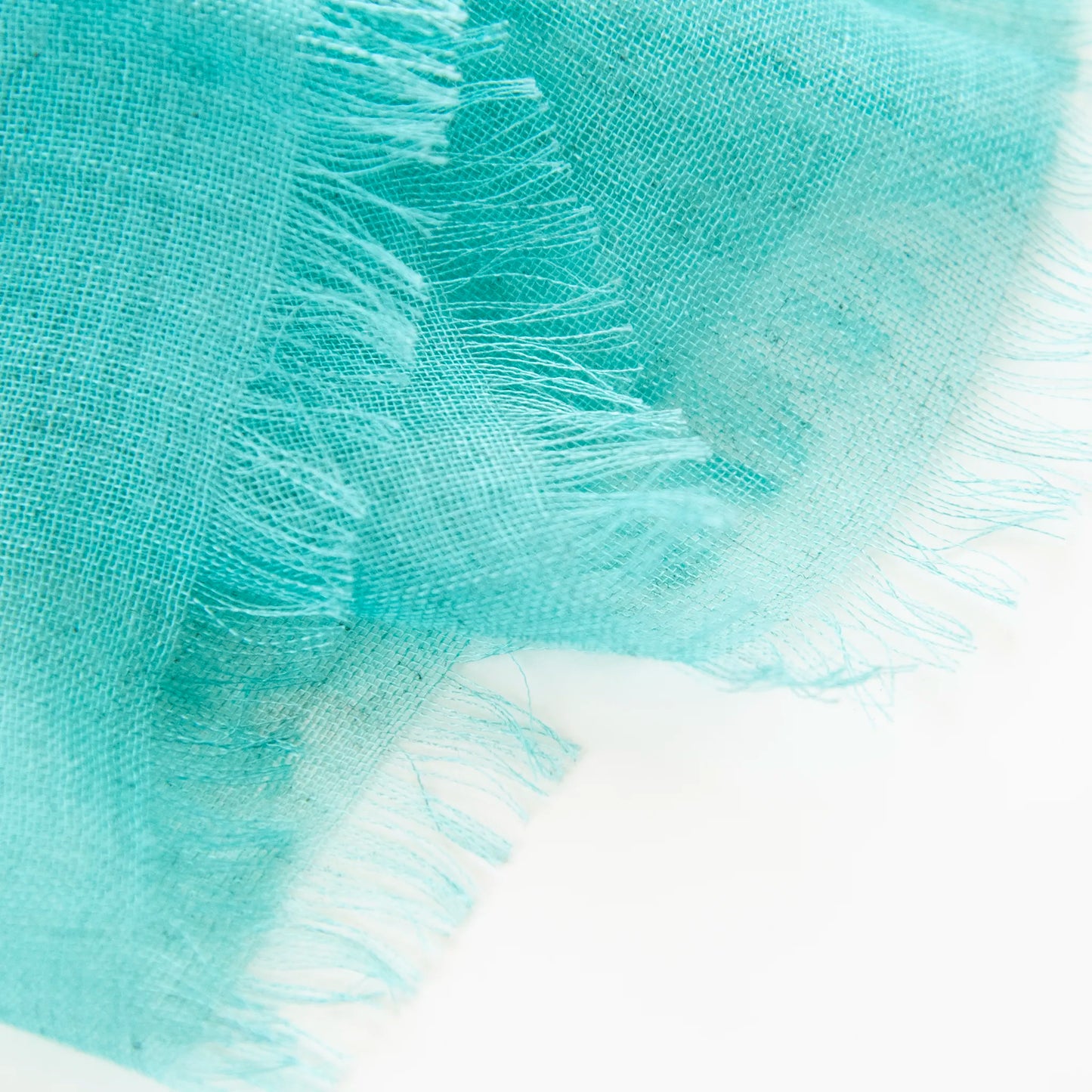 Dettagli e texture della Pashmina in cashmere e modal verde a tessitura twill, pregiata manifattura Made in Italy, sottile ed elegante adatta a ogni stagione.