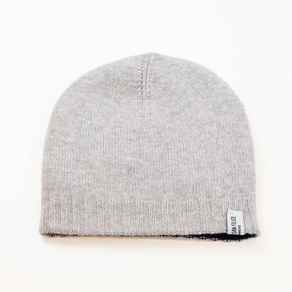 Cuffia doubleface grigio e blu in 100% Cashmere, Made in Italy. Pratica e versatile, può essere indossata con o senza risvolto. Trama rasata e pregiata manifattura per una vestibilità confortevole e di qualità.