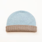 Cuffia doubleface beige e celeste in 100% Cashmere, Made in Italy. Pratica e versatile, può essere indossata con o senza risvolto. Trama rasata e pregiata manifattura per una vestibilità confortevole e di qualità.