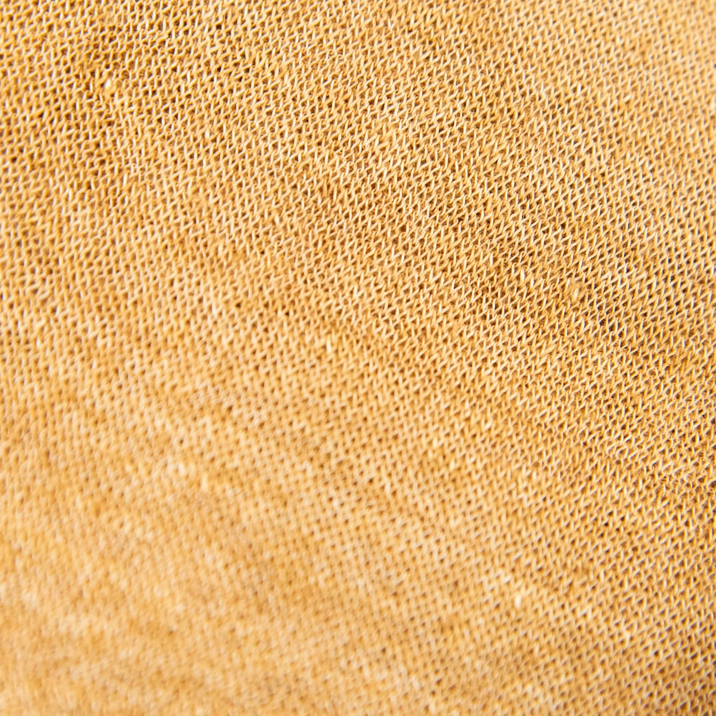 Dettagli e texture della mantellina in 100% Lino senape, Made in Italy, praticità e comfort con tre diverse vestibilità per ogni esigenza.