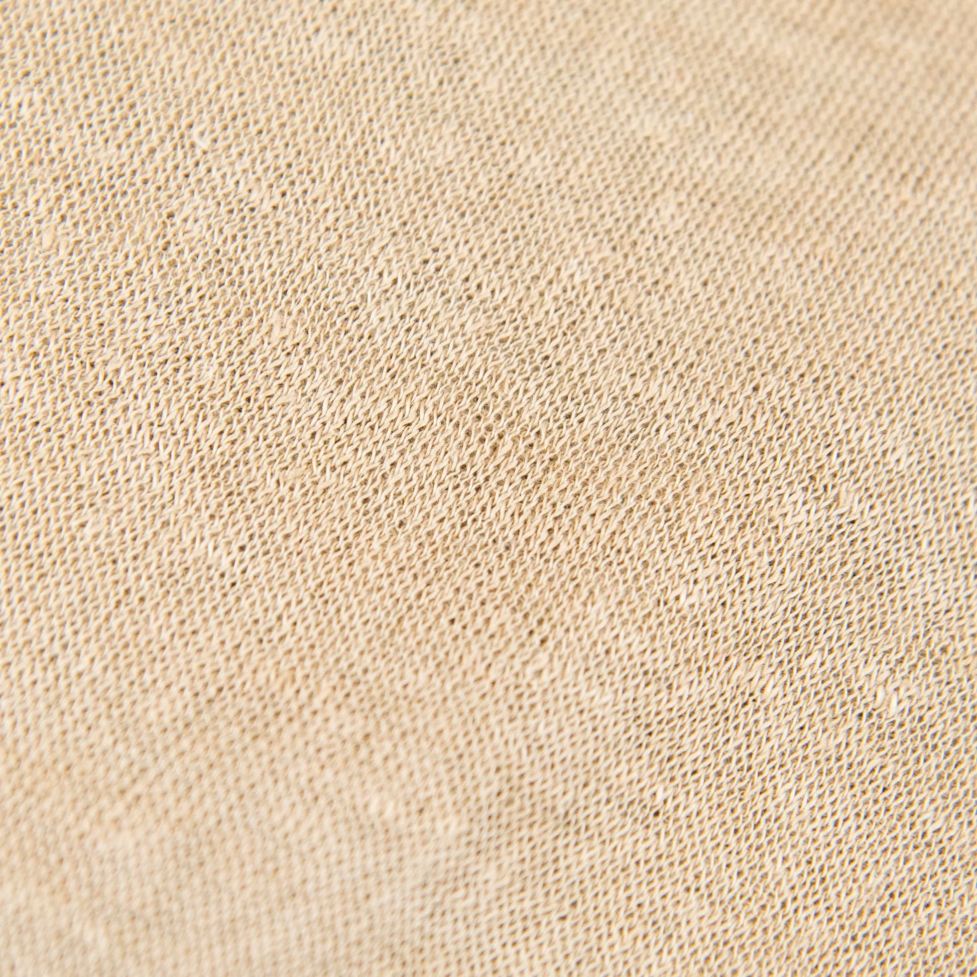 Dettagli e texture tessuto della mantellina in 100% Lino beige, Made in Italy, praticità e comfort con tre diverse vestibilità per ogni esigenza.