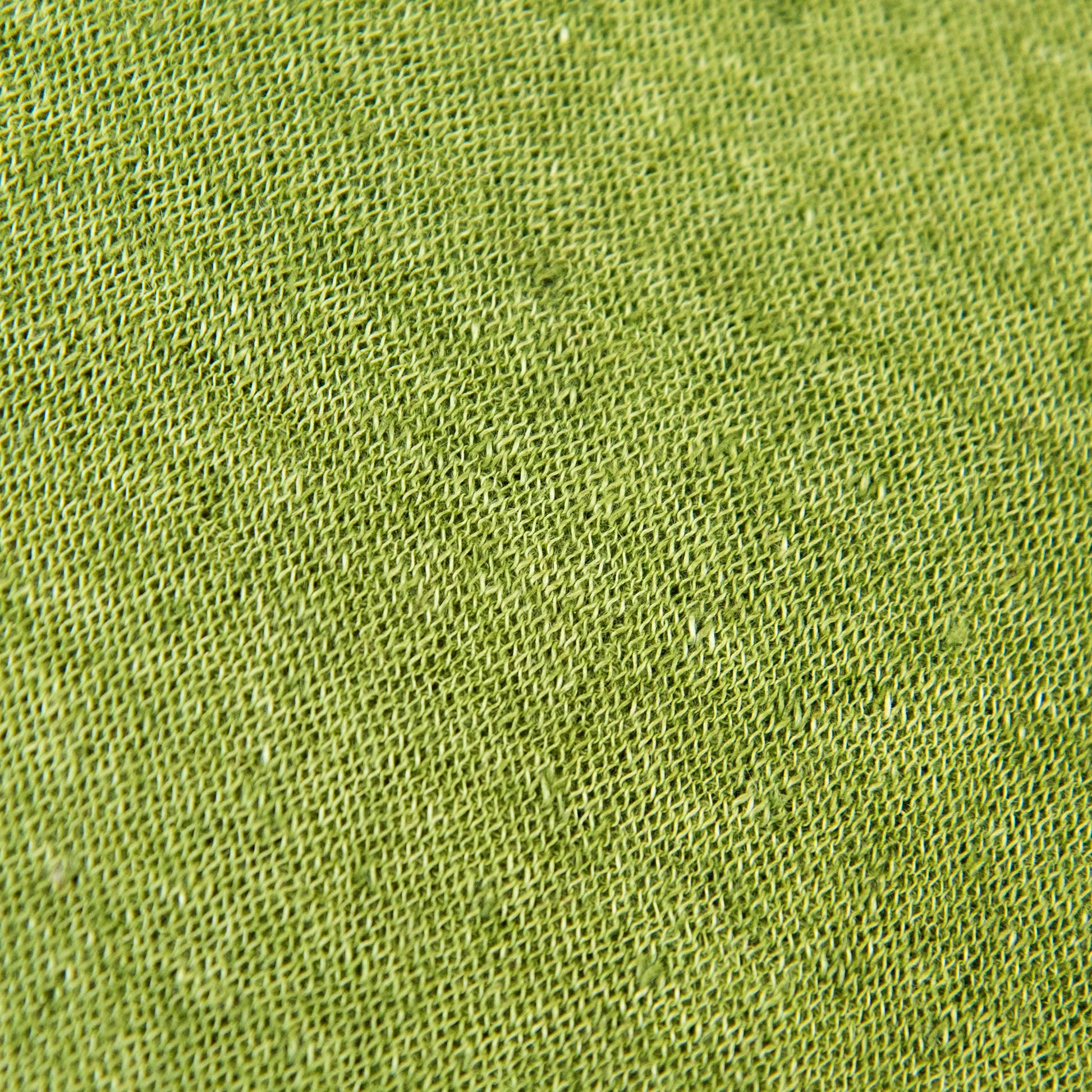 Dettagli e texture tessuto della mantellina in 100% Lino verde, Made in Italy, praticità e comfort con tre diverse vestibilità per ogni esigenza.