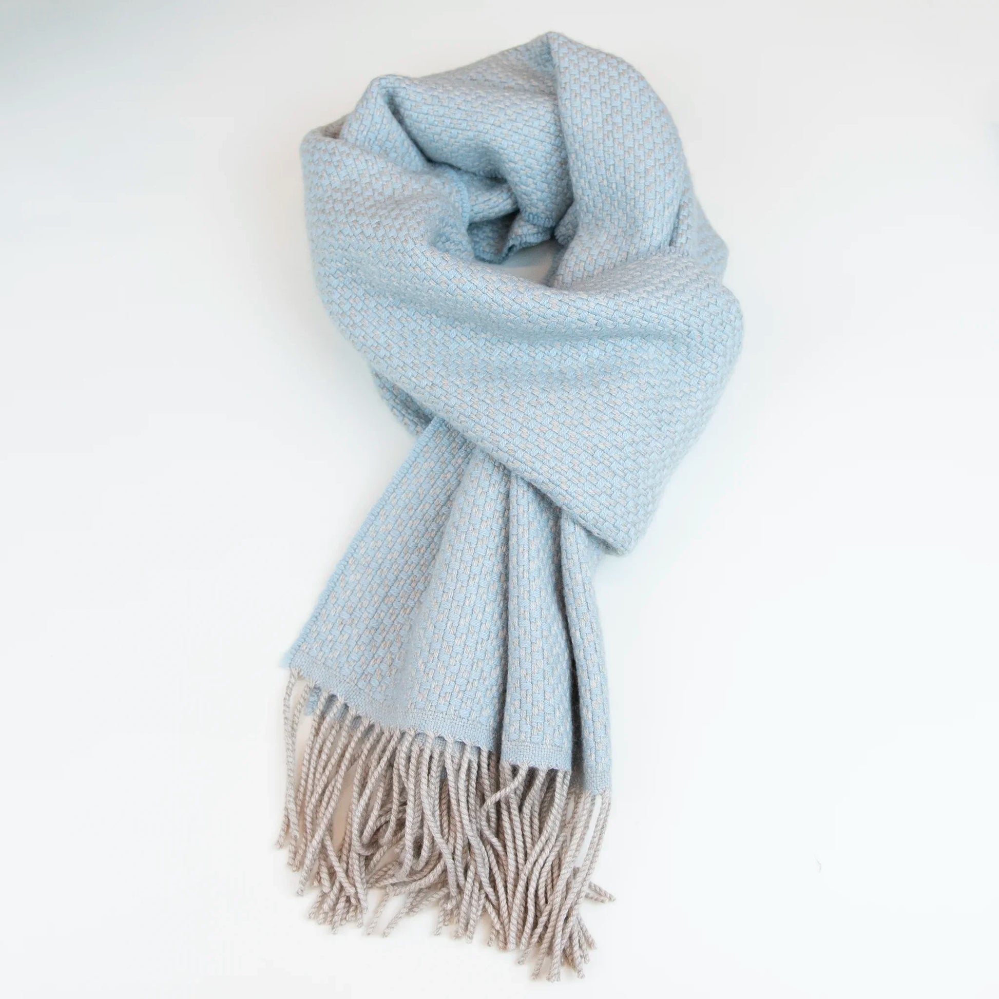 Sciarpa in cashmere e seta celeste Made in Italy. La seta dona luminosità alla trama, mentre i telai antichi ne garantiscono durata nel tempo.