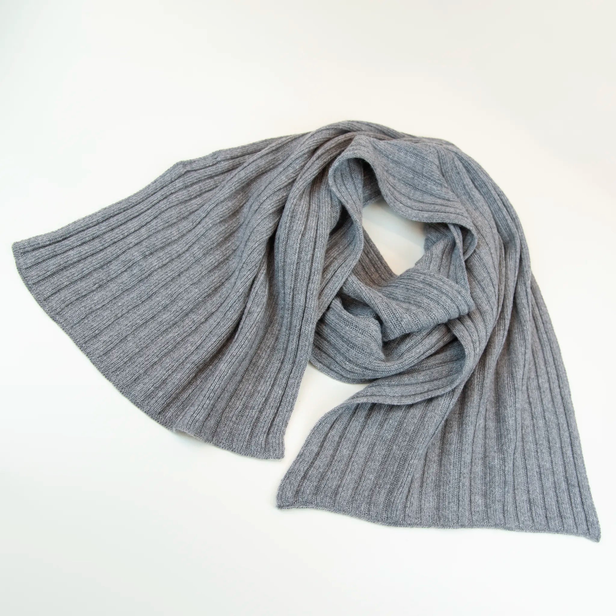 Sciarpa in 100% cashmere grigia, Made in Italy, con trama artigianale realizzata su antichi telai. La struttura robusta e la durata eccezionale del tessuto offrono calore, comfort e leggerezza. Perfetta per aggiungere un tocco di eleganza a qualsiasi outfit, adatta sia a look casual che sofisticati.