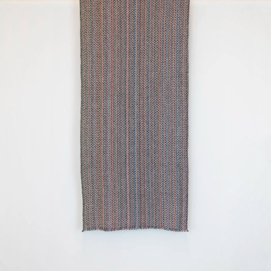 Sciarpa in 100% cashmere di altissima qualità, Made in Italy, realizzata su telai in legno manuali degli anni '30. La base in vello di capra non colorato si intreccia con 100 fili di diverse tonalità, creando una profondità cromatica unica e un equilibrio armonioso di colori. Il risultato è un intreccio vibrante che esalta la morbidezza, la leggerezza e l'eleganza naturale del cashmere. Un accessorio raffinato, frutto della creatività di designer specializzati.