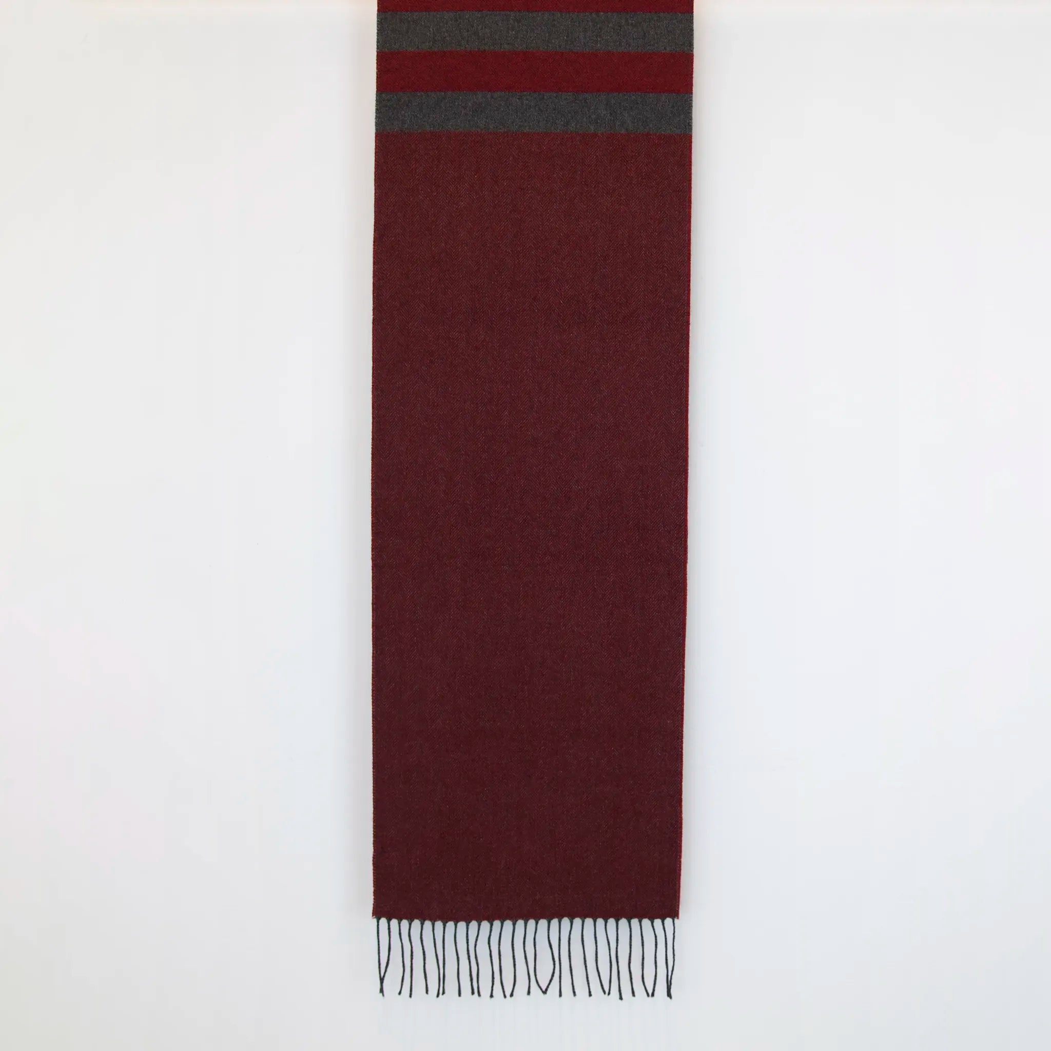 Sciarpa in cashmere e seta, rossa e grigia, Made in Italy, con accostamento di due pattern intramontabili: riga e spinato. Curata nei minimi dettagli, offre straordinaria morbidezza e un comfort avvolgente, rendendola un accessorio elegante e versatile.