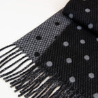 Dettaglio e texture tessuto del Sciarpa in cashmere e seta, nero e grigio, Made in Italy, morbida e calda, con lucentezza naturale della seta. Pattern a pois in negativo sulla parte interna, per una sciarpa versatile, indossabile in due modi diversi.