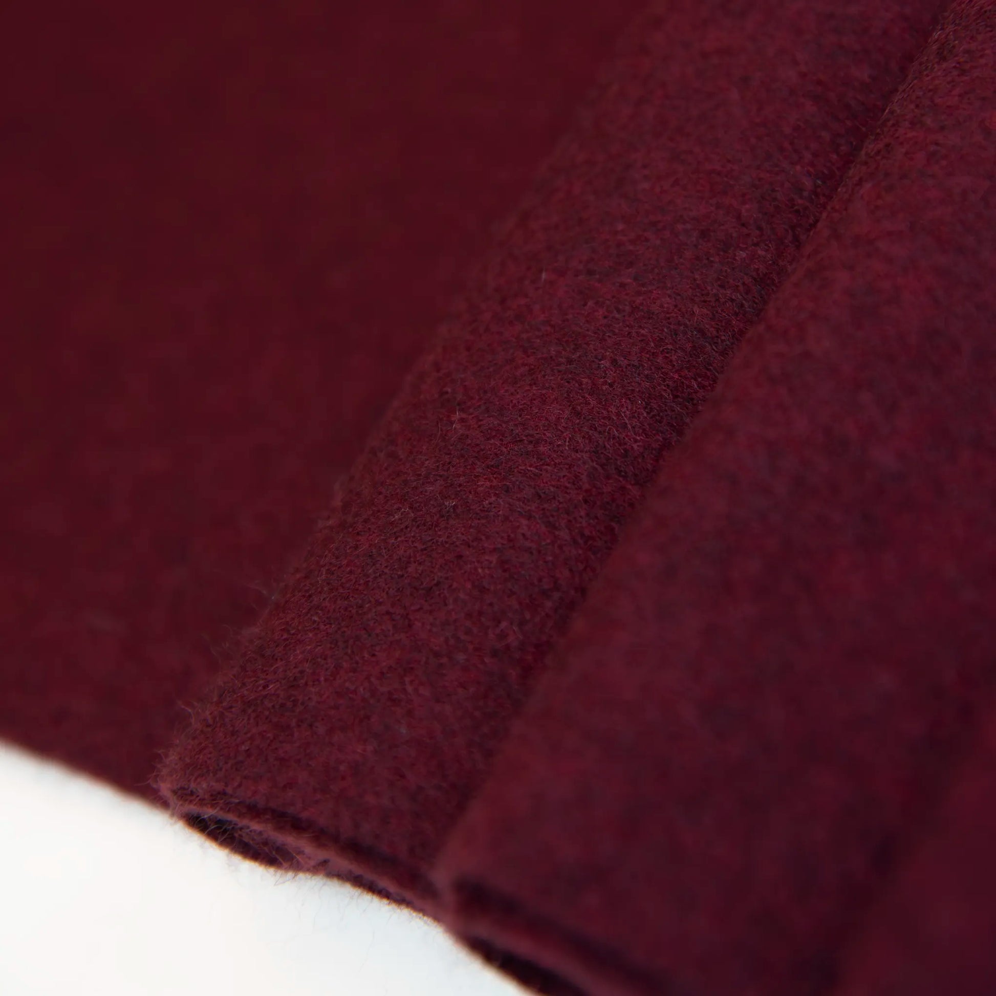 Dettaglio e texture tessuto della Sciarpa in cashmere e seta bordeaux, Made in Italy, con struttura in panno rasato che le conferisce leggerezza e morbidezza avvolgente al tatto. Comoda e versatile, perfetta per essere indossata in ogni occasione.