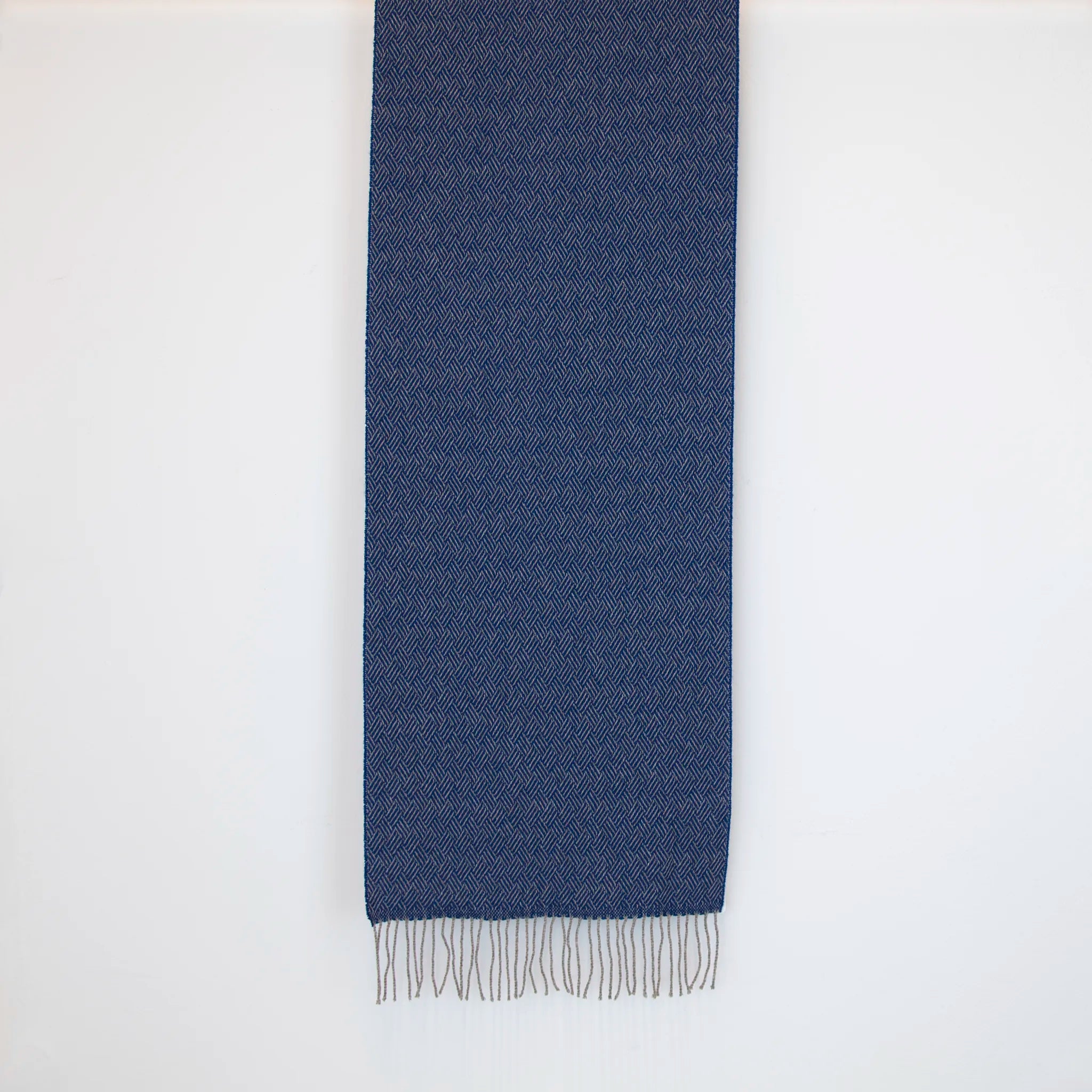 Sciarpa in 100% cashmere blu, Made in Italy, con intramontabile pattern ad intreccio e lavorazione leggera in 3D che accentua la percezione al tatto. Il cashmere di alta qualità offre straordinaria finezza, proprietà termoisolanti e garantisce calore, protezione e leggerezza.