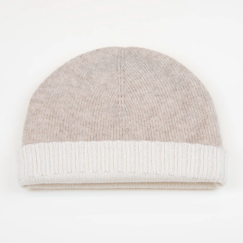 Cuffia doubleface beige e panna in 100% Cashmere, Made in Italy. Pratica e versatile, può essere indossata con o senza risvolto. Trama rasata e pregiata manifattura per una vestibilità confortevole e di qualità.