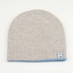 Cuffia doubleface beige e celeste in 100% Cashmere, Made in Italy. Pratica e versatile, può essere indossata con o senza risvolto. Trama rasata e pregiata manifattura per una vestibilità confortevole e di qualità.