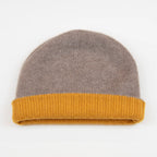 Cuffia doubleface giallo e marrone in 100% Cashmere, Made in Italy. Pratica e versatile, può essere indossata con o senza risvolto. Trama rasata e pregiata manifattura per una vestibilità confortevole e di qualità.