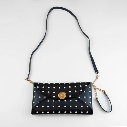 Clutch in pelle nera borchiata con chiusura a calamita, polsiera e tracolla per un pratico trasporto, Made in Italy, realizzata interamente a mano senza cuciture, secondo la tradizione degli antichi sellai Toscani, per robustezza e durata.