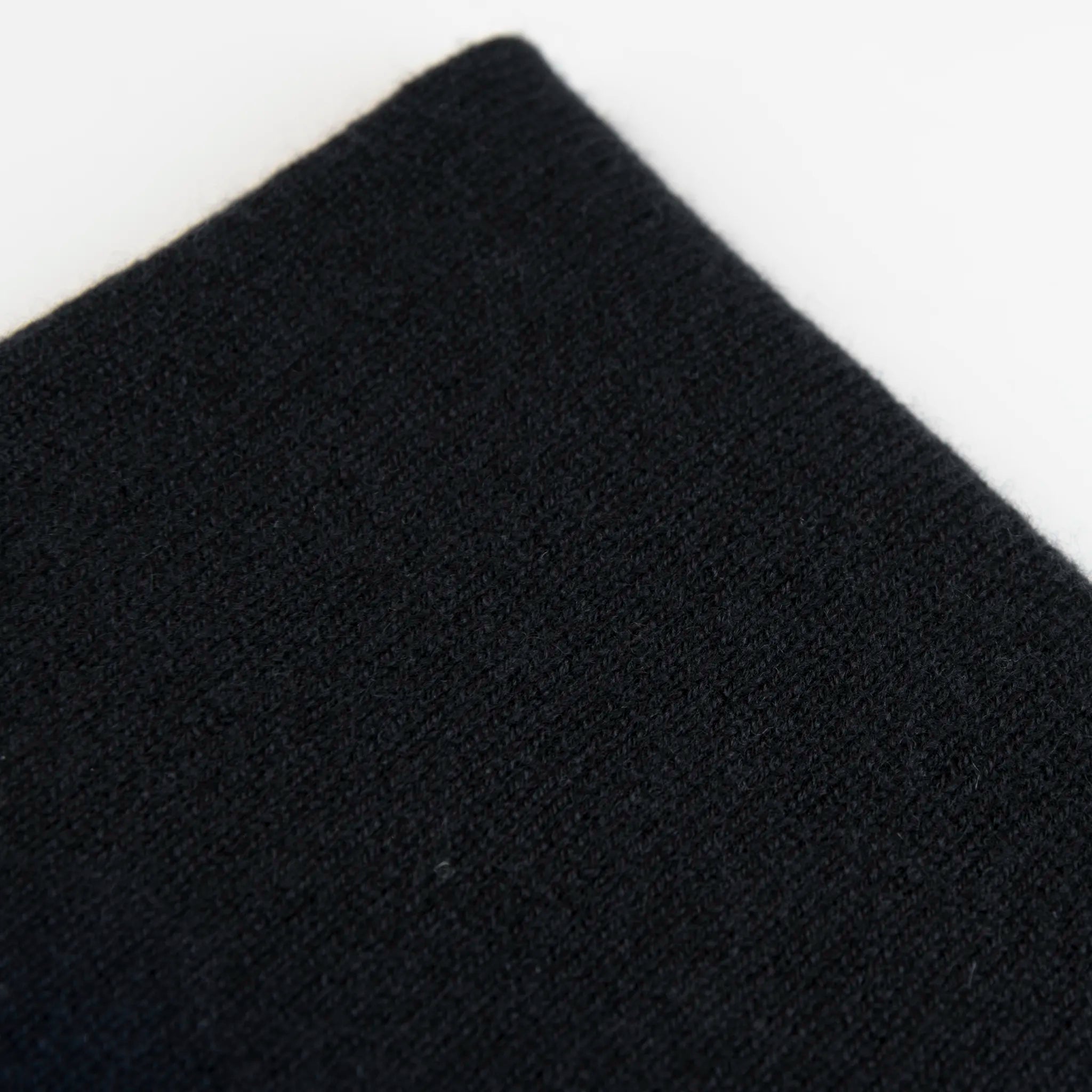 Dettaglio e texture tessuto del Collo in 100% cashmere nero, versatile, utilizzabile come scaldacollo, fascia per capelli, passamontagna o cappello con sbuffo, Made in Italy, morbido e caldo.
